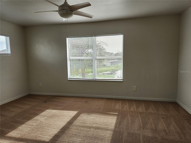 empty room featuring carpet flooring and ceiling fan