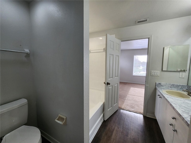 full bathroom featuring vanity, toilet, hardwood / wood-style floors, and shower with separate bathtub