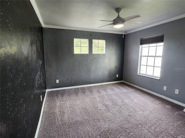 carpeted spare room featuring ceiling fan, crown molding, and a textured ceiling