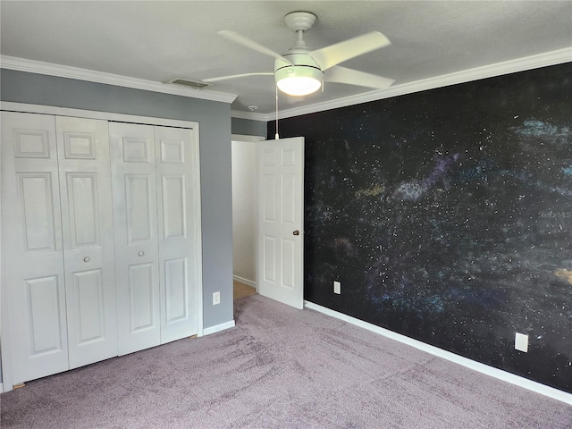 unfurnished bedroom with a closet, ceiling fan, carpet, and ornamental molding