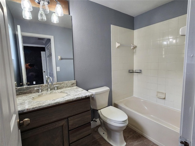 full bathroom with tiled shower / bath, toilet, and vanity