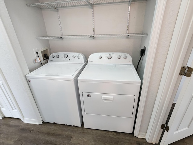 laundry area with separate washer and dryer and dark hardwood / wood-style floors