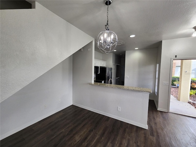 kitchen featuring stainless steel fridge, kitchen peninsula, white cabinets, and dark hardwood / wood-style floors