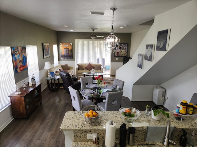 living room with a healthy amount of sunlight, ceiling fan, and dark hardwood / wood-style flooring