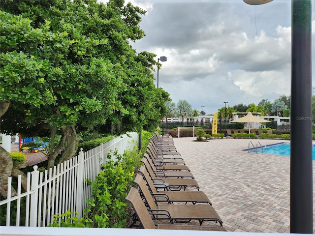 view of property's community with a patio and a pool