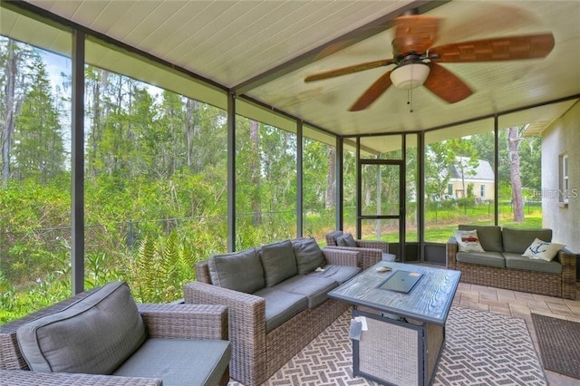 sunroom / solarium featuring ceiling fan