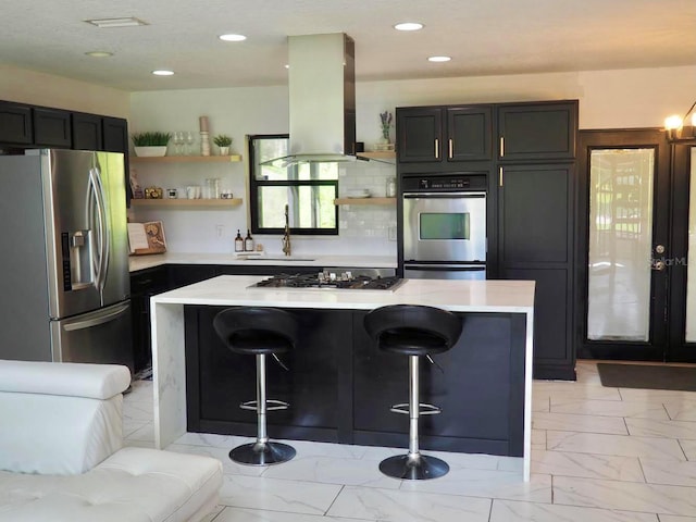 kitchen with marble finish floor, island exhaust hood, open shelves, stainless steel appliances, and a sink