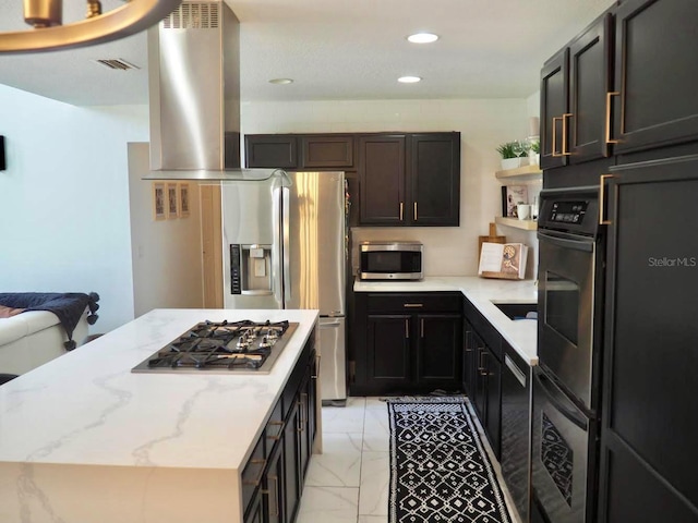 kitchen with marble finish floor, island exhaust hood, stainless steel appliances, visible vents, and light stone countertops