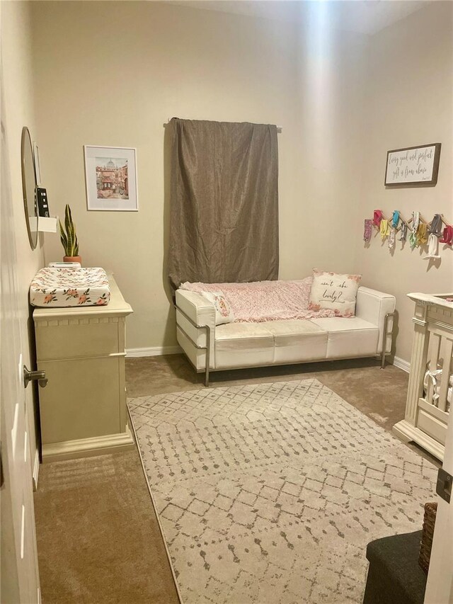 carpeted bedroom featuring baseboards