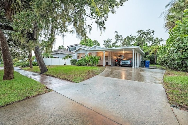 view of front of property featuring a front yard and a carport