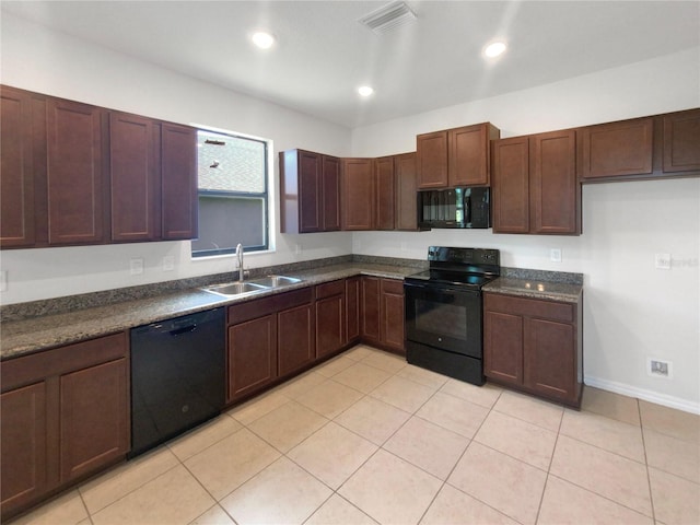 kitchen featuring black appliances, light tile patterned flooring, and sink