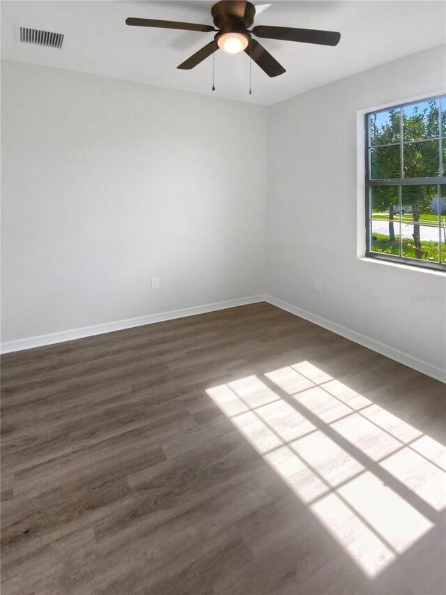 13292 Sea Bridge Dr, Hudson, FL 34669 - empty room with dark wood-style flooring, baseboards, ceiling fan, and visible vents
