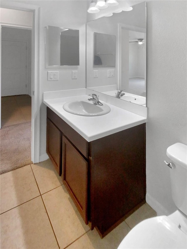 bathroom featuring vanity, toilet, and tile patterned floors