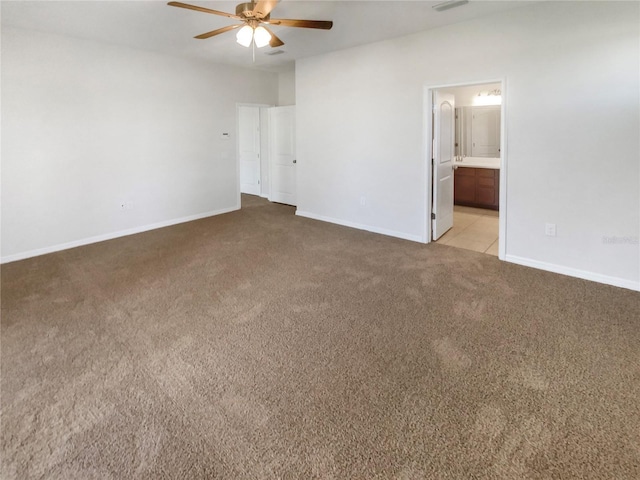 13292 Sea Bridge Dr, Hudson, FL 34669 - unfurnished bedroom with light carpet, ensuite bath, baseboards, visible vents, and ceiling fan