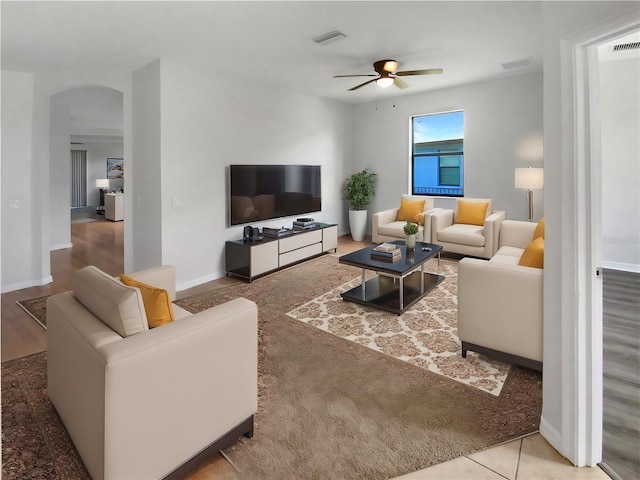 13292 Sea Bridge Dr, Hudson, FL 34669 - living room featuring a ceiling fan, arched walkways, baseboards, and visible vents