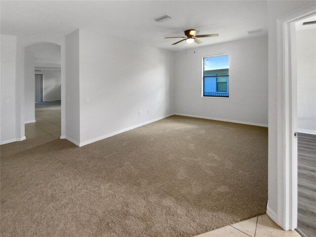 13292 Sea Bridge Dr, Hudson, FL 34669 - carpeted spare room featuring visible vents, arched walkways, baseboards, and ceiling fan