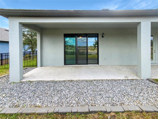 13292 Sea Bridge Dr, Hudson, FL 34669 - exterior space with stucco siding, fence, and a patio