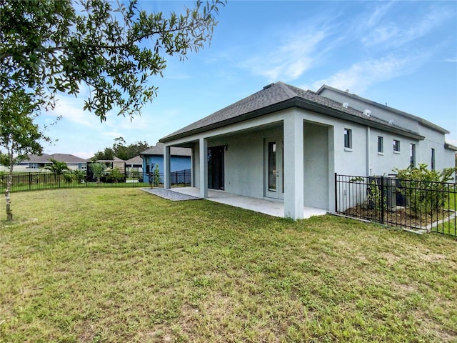 13292 Sea Bridge Dr, Hudson, FL 34669 - back of house with a fenced backyard, stucco siding, a patio area, and a yard