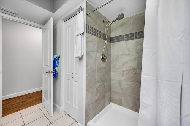 bathroom featuring tile patterned flooring and curtained shower