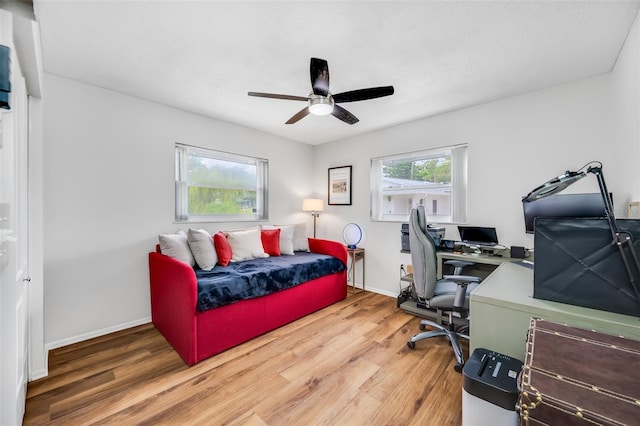 bedroom with ceiling fan and hardwood / wood-style floors