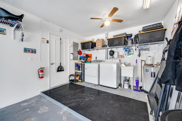 clothes washing area with ceiling fan, separate washer and dryer, and a textured ceiling