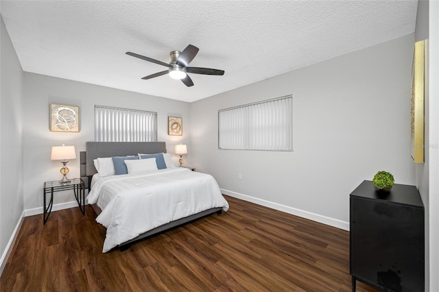 bedroom featuring ceiling fan, wood finished floors, baseboards, and a textured ceiling