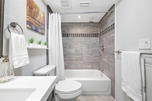 full bath featuring visible vents, toilet, shower / tub combo, and a textured wall