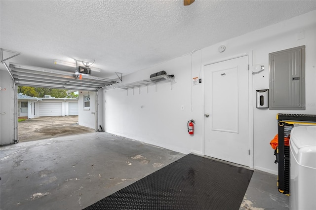 garage featuring electric panel and a garage door opener