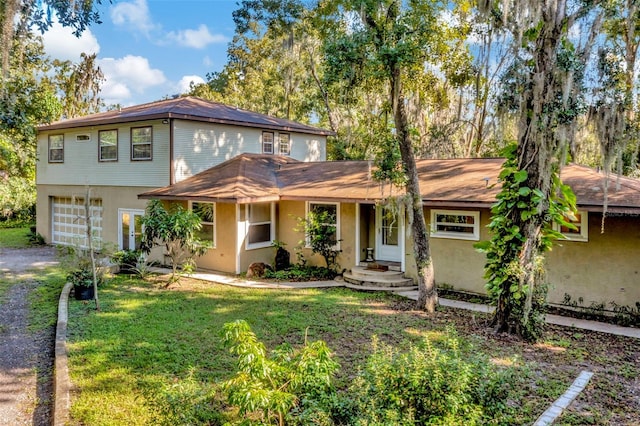 view of front of property featuring a garage and a front lawn