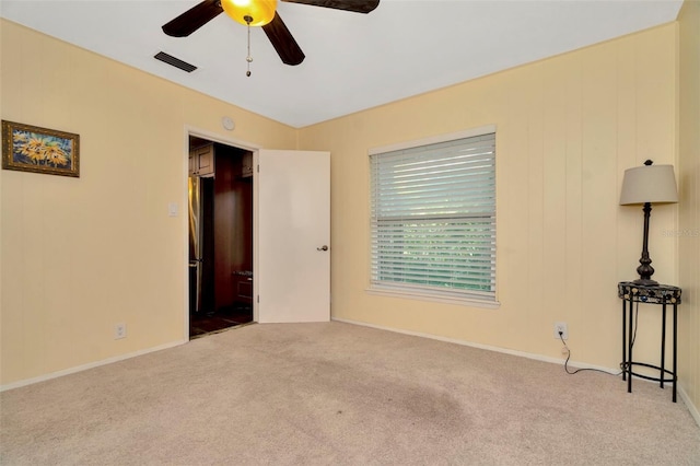 carpeted empty room with ceiling fan