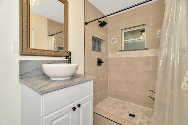 bathroom featuring vanity and curtained shower