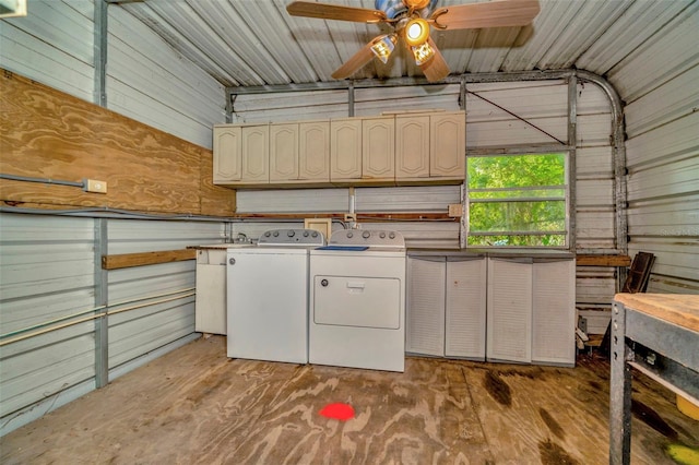 laundry area with washing machine and dryer, ceiling fan, and wooden walls