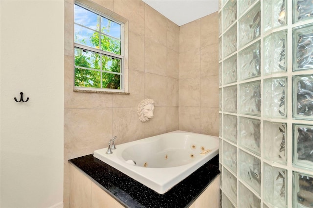 bathroom with tile walls and a bathtub