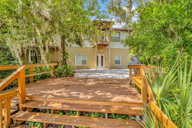 rear view of property with a wooden deck