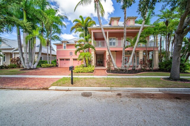 825 Islebay Dr, Apollo Beach, FL 33572 - view of front of house with a front lawn, decorative driveway, a garage, and stucco siding