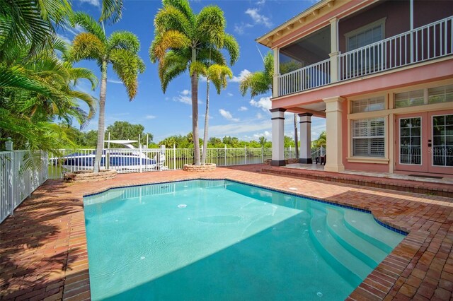 825 Islebay Dr, Apollo Beach, FL 33572 - view of swimming pool featuring french doors, a fenced backyard, a fenced in pool, and a patio