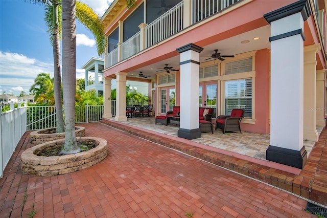 view of patio featuring a balcony, ceiling fan, and outdoor lounge area