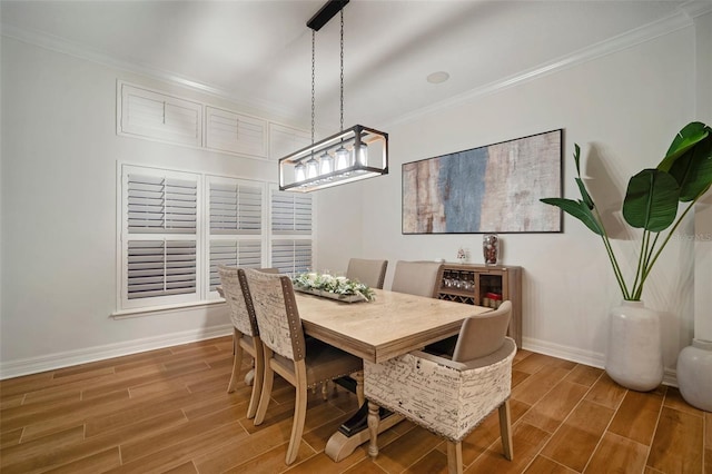 dining room with crown molding and wood-type flooring