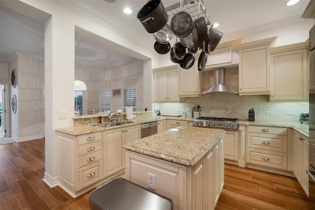 825 Islebay Dr, Apollo Beach, FL 33572 - kitchen with wall chimney range hood, wood finished floors, ornamental molding, and a sink