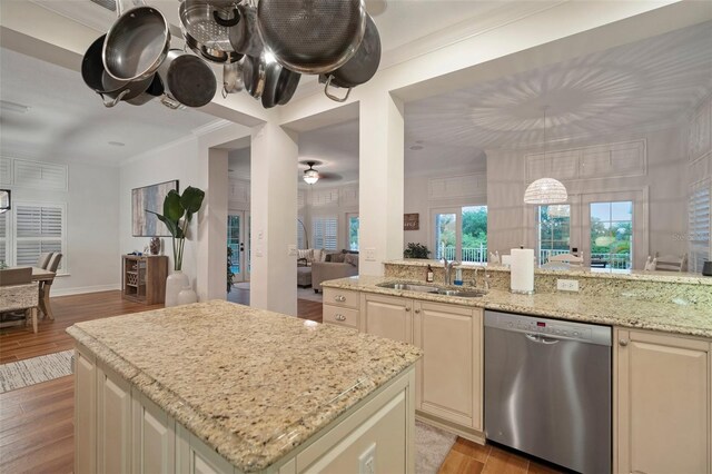 825 Islebay Dr, Apollo Beach, FL 33572 - kitchen with crown molding, a sink, dishwasher, open floor plan, and cream cabinets