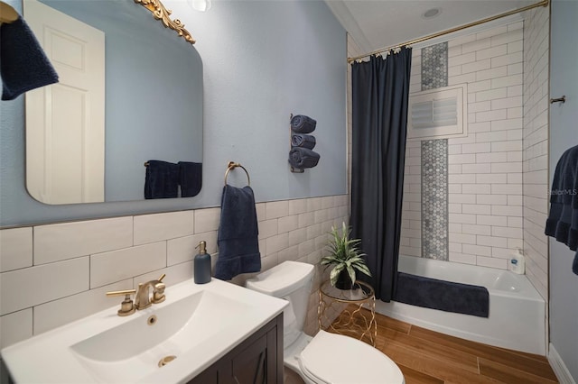 full bathroom featuring toilet, vanity, shower / bath combo with shower curtain, wood-type flooring, and decorative backsplash