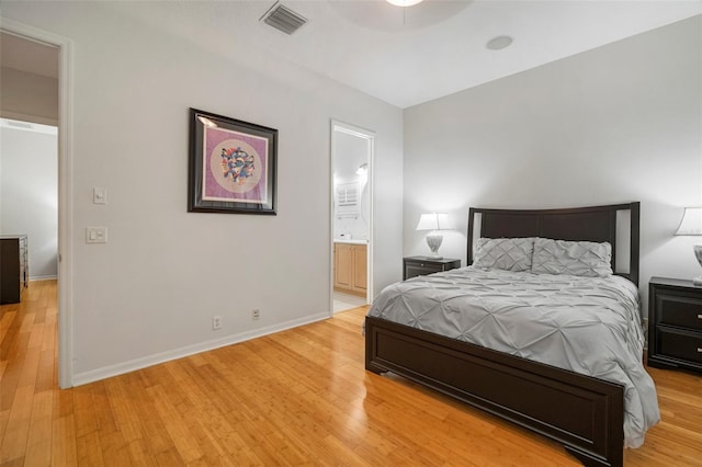 bedroom with light hardwood / wood-style flooring and connected bathroom