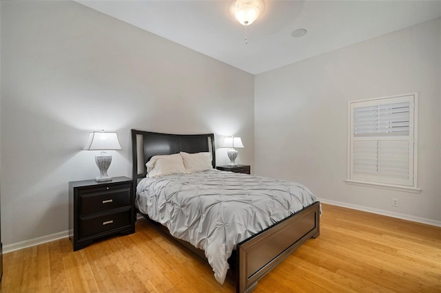 bedroom featuring lofted ceiling and light hardwood / wood-style floors