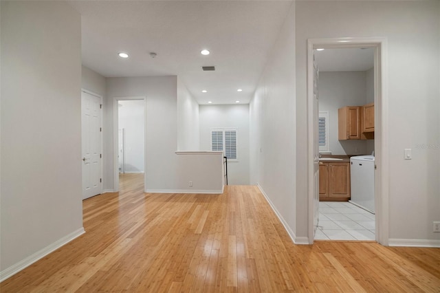 825 Islebay Dr, Apollo Beach, FL 33572 - hall with baseboards, visible vents, and light wood-style flooring