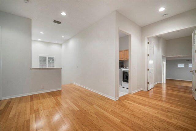 825 Islebay Dr, Apollo Beach, FL 33572 - unfurnished room with light wood-type flooring, washer / clothes dryer, baseboards, visible vents, and recessed lighting