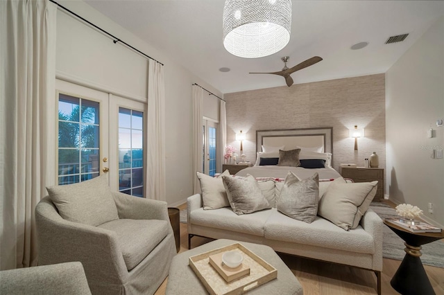 825 Islebay Dr, Apollo Beach, FL 33572 - bedroom with baseboards, wood finished floors, an accent wall, and access to outside
