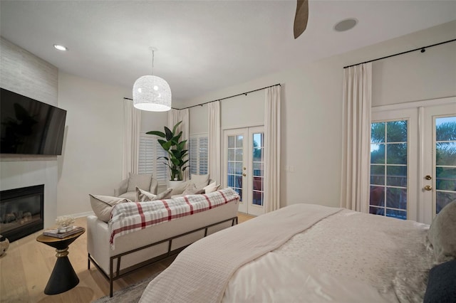 825 Islebay Dr, Apollo Beach, FL 33572 - bedroom with french doors, access to outside, a fireplace, and wood finished floors