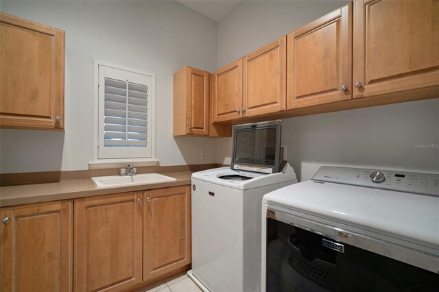 825 Islebay Dr, Apollo Beach, FL 33572 - clothes washing area with washer and dryer, cabinet space, a sink, and light tile patterned floors
