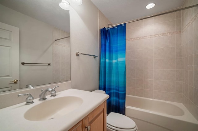 full bathroom featuring vanity, toilet, shower / tub combo with curtain, and a textured ceiling