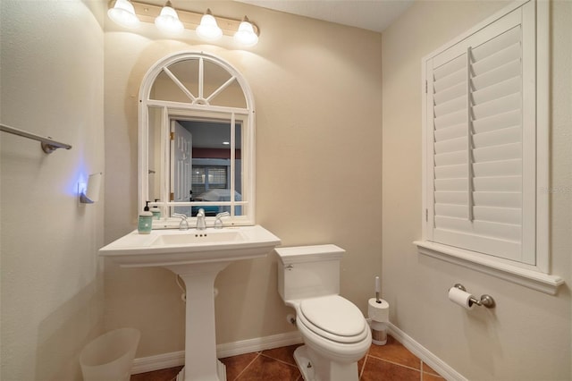 bathroom with toilet and tile patterned floors